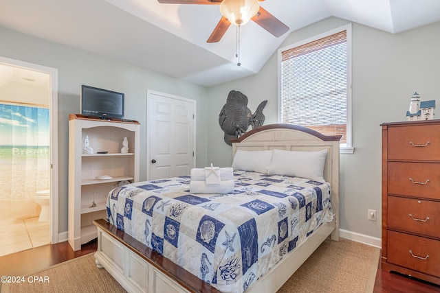 bedroom featuring hardwood / wood-style flooring, ceiling fan, lofted ceiling, and ensuite bathroom