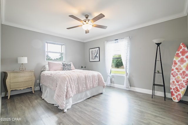 bedroom with hardwood / wood-style floors, ceiling fan, and ornamental molding