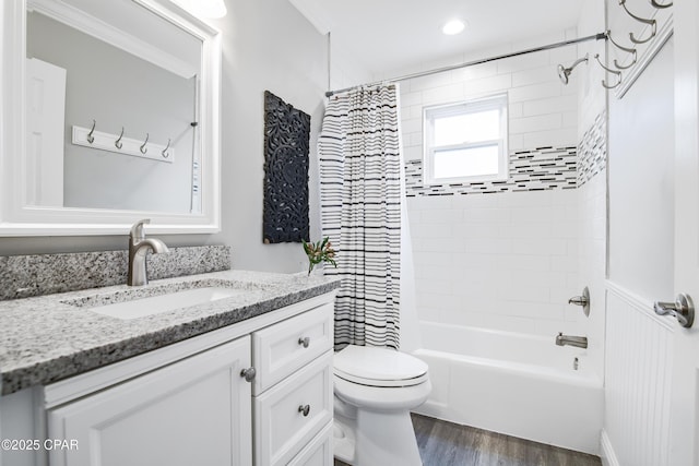 full bathroom featuring hardwood / wood-style flooring, crown molding, vanity, and toilet