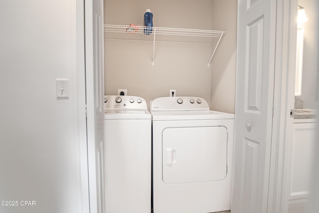 washroom featuring washer and clothes dryer