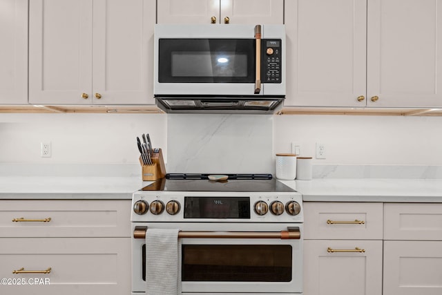 kitchen with white cabinets and high end range