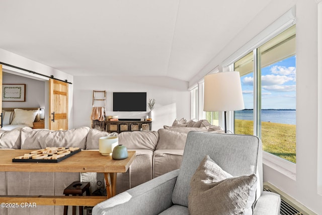 living room featuring a barn door and lofted ceiling