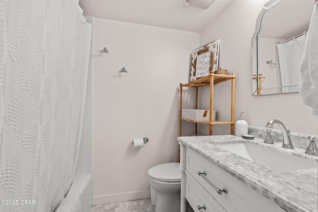 bathroom featuring tile patterned flooring, vanity, and toilet