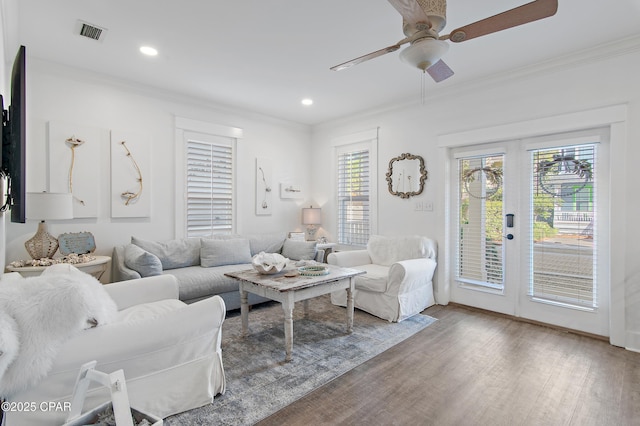 living room with crown molding, ceiling fan, hardwood / wood-style floors, and french doors