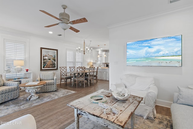 living room featuring crown molding, ceiling fan with notable chandelier, and hardwood / wood-style floors