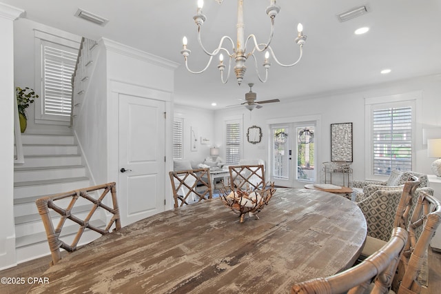 dining space with hardwood / wood-style flooring, ornamental molding, ceiling fan with notable chandelier, and french doors