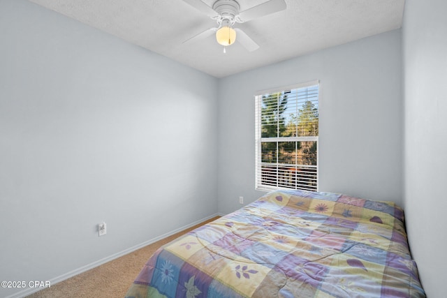 bedroom featuring ceiling fan and carpet