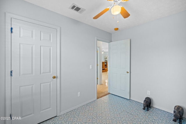 unfurnished bedroom with a textured ceiling and ceiling fan