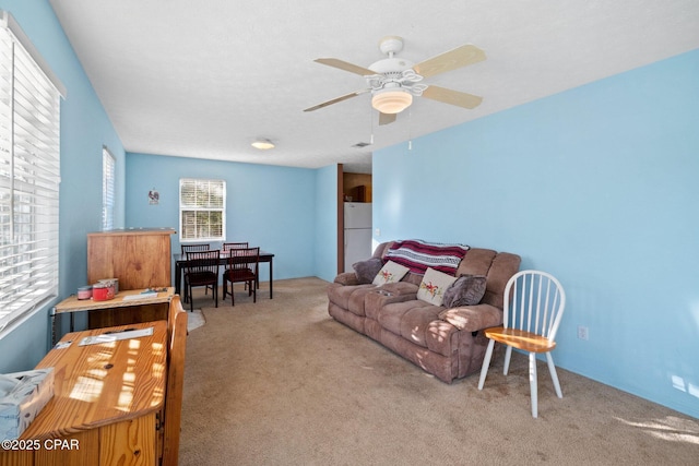 carpeted living room featuring ceiling fan