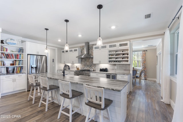 6509 W Sundew Marsh Trl, Panama City Beach, FL 32413 - kitchen with wall chimney exhaust hood, open shelves, appliances with stainless steel finishes, decorative backsplash, and white cabinetry