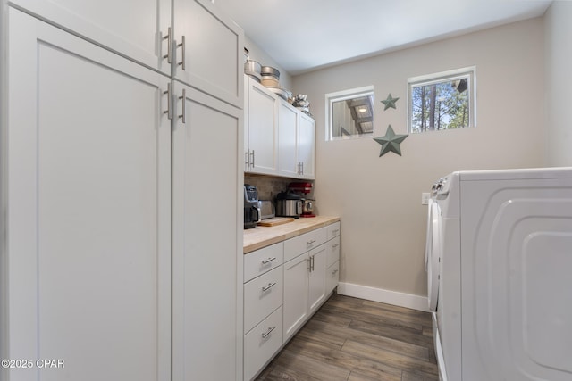 6509 W Sundew Marsh Trl, Panama City Beach, FL 32413 - laundry room featuring washer / dryer, cabinet space, baseboards, and dark wood-style floors