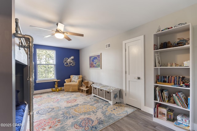 6509 W Sundew Marsh Trl, Panama City Beach, FL 32413 - sitting room featuring ceiling fan, wood finished floors, and baseboards
