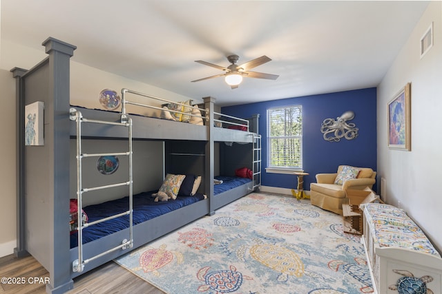 6509 W Sundew Marsh Trl, Panama City Beach, FL 32413 - bedroom with wood finished floors, a ceiling fan, and baseboards