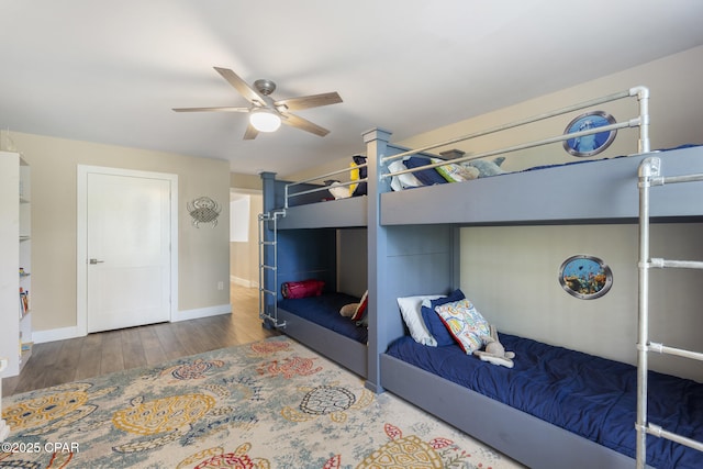 6509 W Sundew Marsh Trl, Panama City Beach, FL 32413 - bedroom with wood finished floors, baseboards, and a ceiling fan