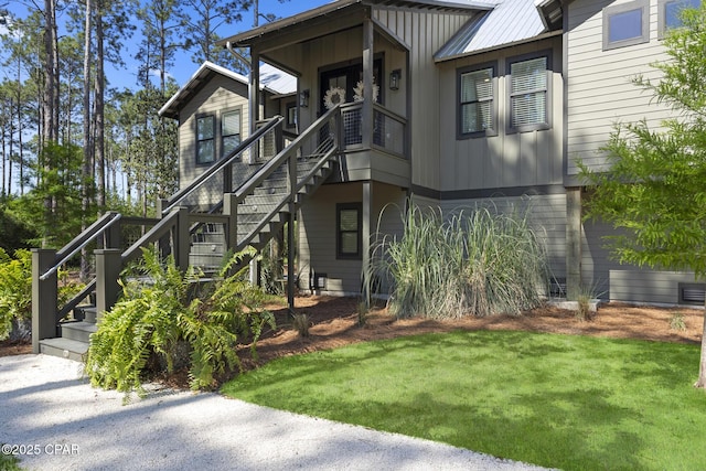 6509 W Sundew Marsh Trl, Panama City Beach, FL 32413 - view of property exterior with stairway and a yard