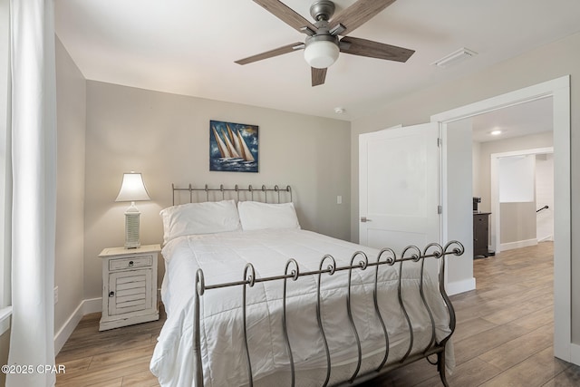 6509 W Sundew Marsh Trl, Panama City Beach, FL 32413 - bedroom with light wood finished floors, baseboards, and ceiling fan