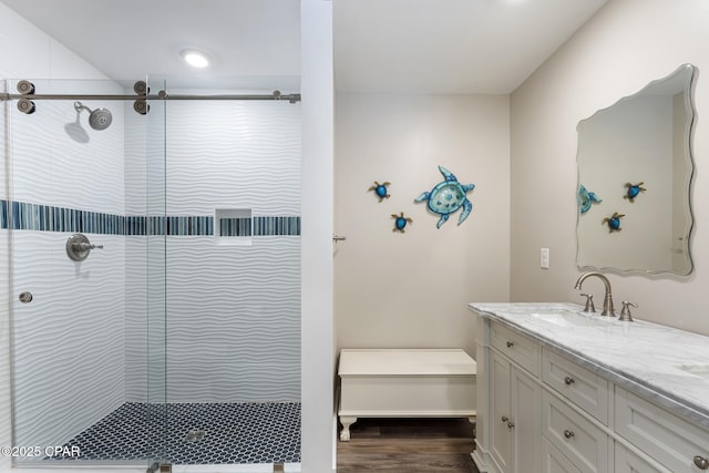 6509 W Sundew Marsh Trl, Panama City Beach, FL 32413 - bathroom featuring tiled shower, vanity, and wood finished floors