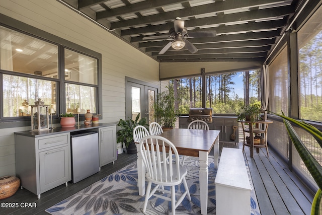 6509 W Sundew Marsh Trl, Panama City Beach, FL 32413 - sunroom with exterior kitchen, ceiling fan, and outdoor dining space