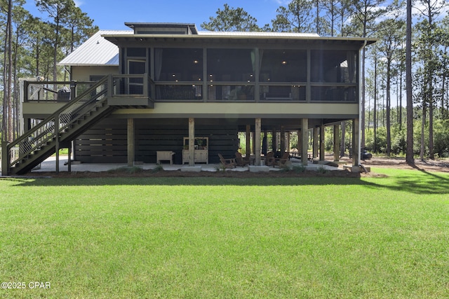 6509 W Sundew Marsh Trl, Panama City Beach, FL 32413 - back of house featuring a sunroom, stairs, a lawn, and a deck