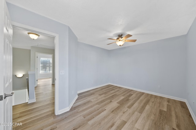 unfurnished room featuring light wood-type flooring and ceiling fan