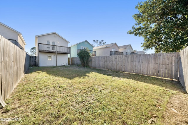 view of yard featuring a balcony