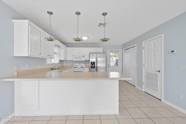 kitchen with pendant lighting, white cabinetry, white appliances, and kitchen peninsula