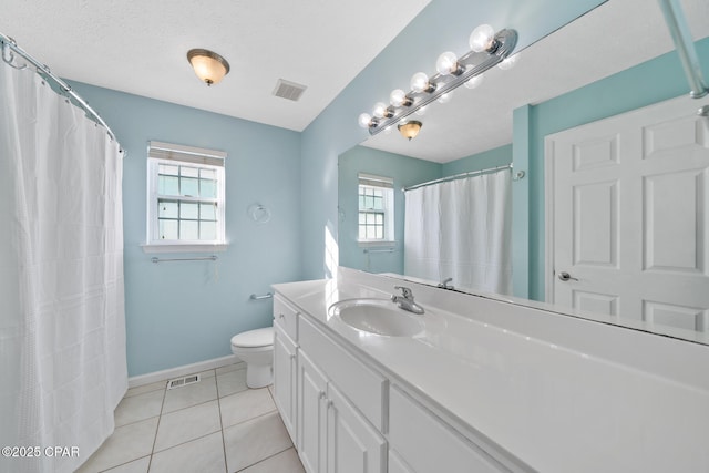 bathroom with tile patterned floors, vanity, toilet, and a textured ceiling