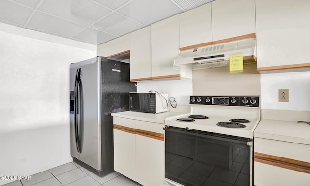 kitchen featuring range with electric cooktop, white cabinets, light tile patterned floors, a paneled ceiling, and stainless steel fridge with ice dispenser