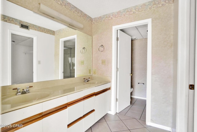 bathroom featuring tile patterned flooring, vanity, and toilet