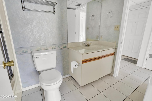 bathroom featuring toilet, tile patterned flooring, and vanity