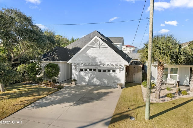 view of front of house with a garage and a front lawn