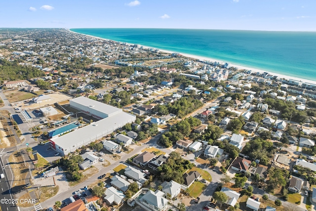 drone / aerial view with a water view and a beach view