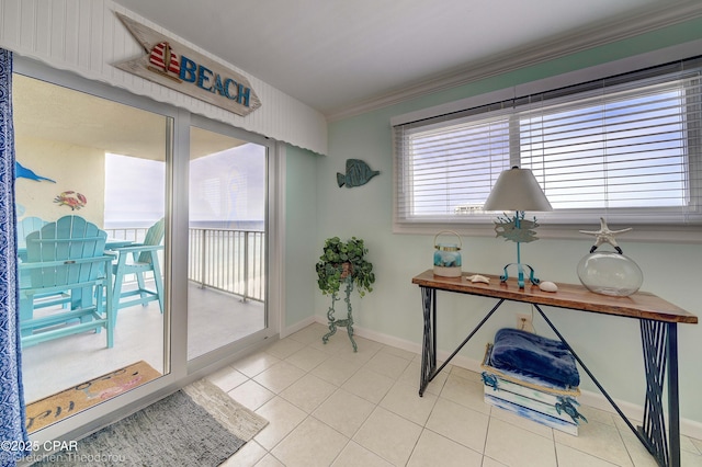 interior space featuring ornamental molding, light tile patterned floors, and plenty of natural light