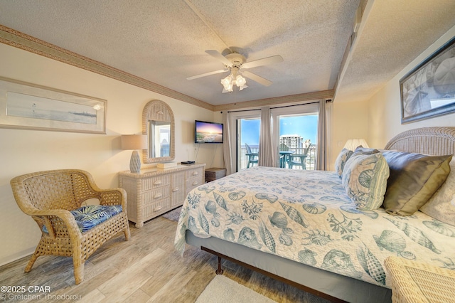 bedroom featuring light wood-type flooring, crown molding, ceiling fan, a textured ceiling, and access to outside