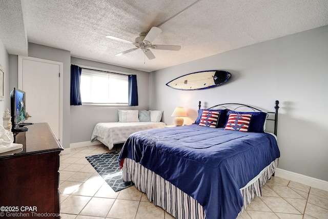 bedroom with light tile patterned flooring, a textured ceiling, and ceiling fan