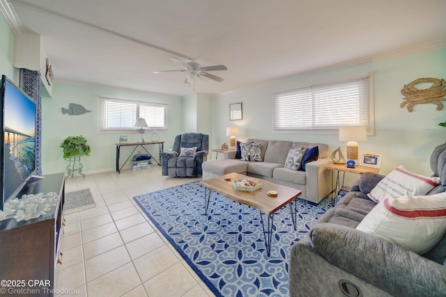 tiled living room with ceiling fan and crown molding