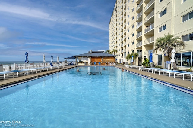 view of swimming pool featuring a gazebo and a water view