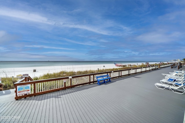 dock area featuring a deck with water view and a view of the beach