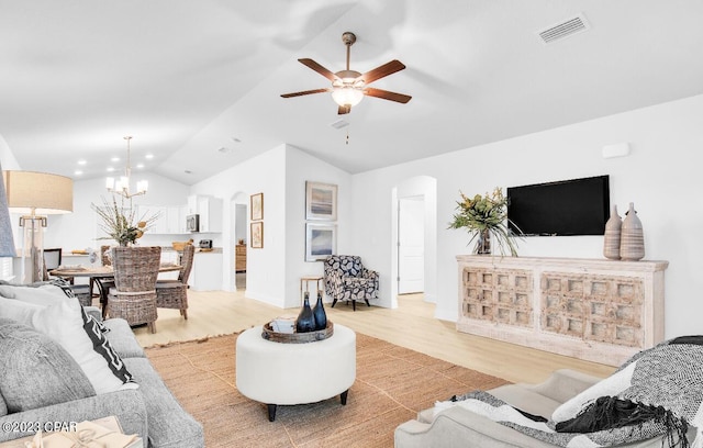 living room with lofted ceiling, ceiling fan with notable chandelier, and light hardwood / wood-style flooring