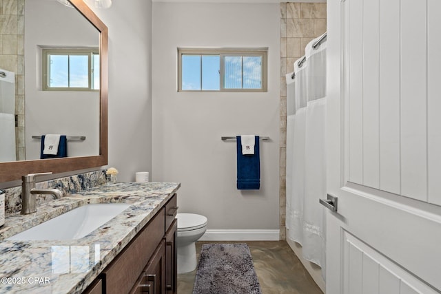 bathroom featuring walk in shower, vanity, and toilet