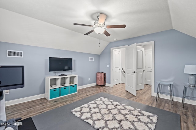 interior space with vaulted ceiling, dark hardwood / wood-style floors, and ceiling fan