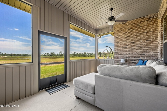 sunroom / solarium featuring ceiling fan