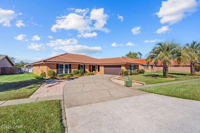 view of front of property featuring a garage and a front yard