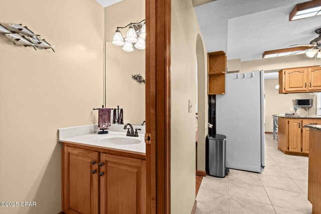 bathroom with vanity, a textured ceiling, tile patterned floors, and ceiling fan