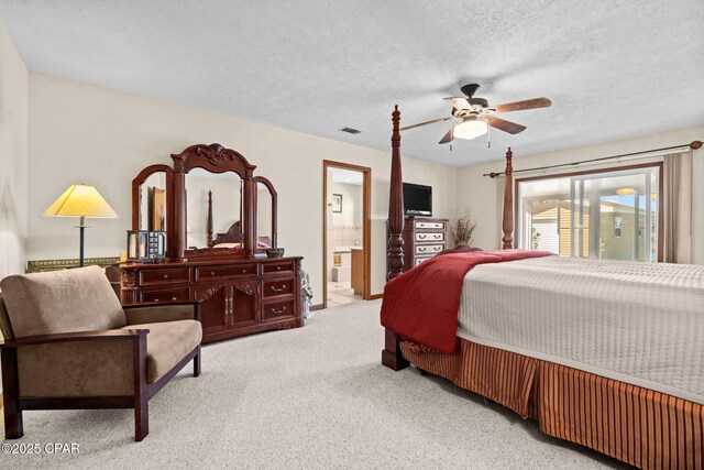 bedroom with connected bathroom, ceiling fan, light colored carpet, and a textured ceiling