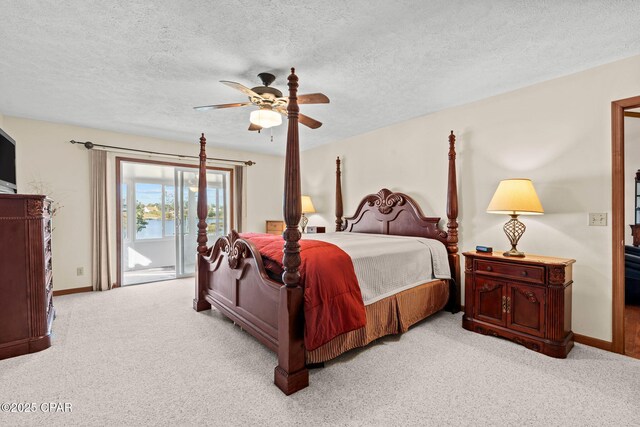 bedroom with a textured ceiling, light colored carpet, access to exterior, and ceiling fan