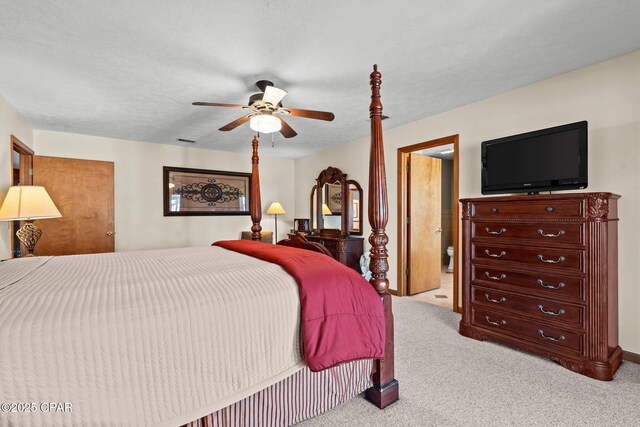 carpeted bedroom featuring a textured ceiling and ceiling fan