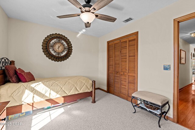 bedroom with ceiling fan, a closet, and carpet floors