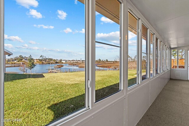 unfurnished sunroom featuring a water view and a wealth of natural light