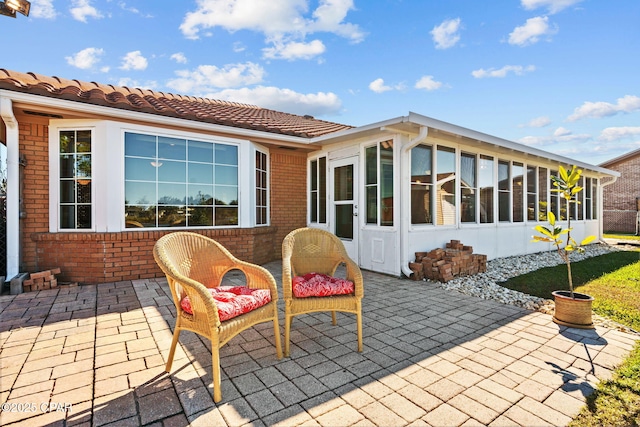 view of patio / terrace featuring a sunroom